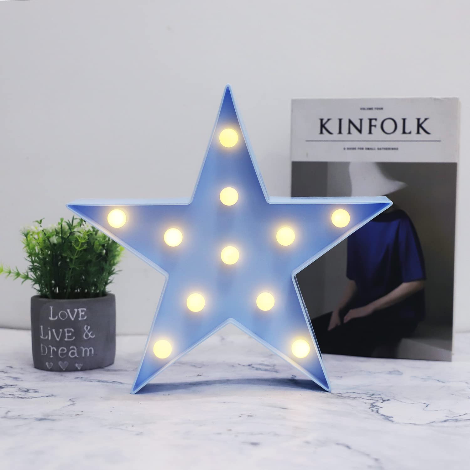 Vicila star night light on table-top provides gentle warm illumination for bedtime.