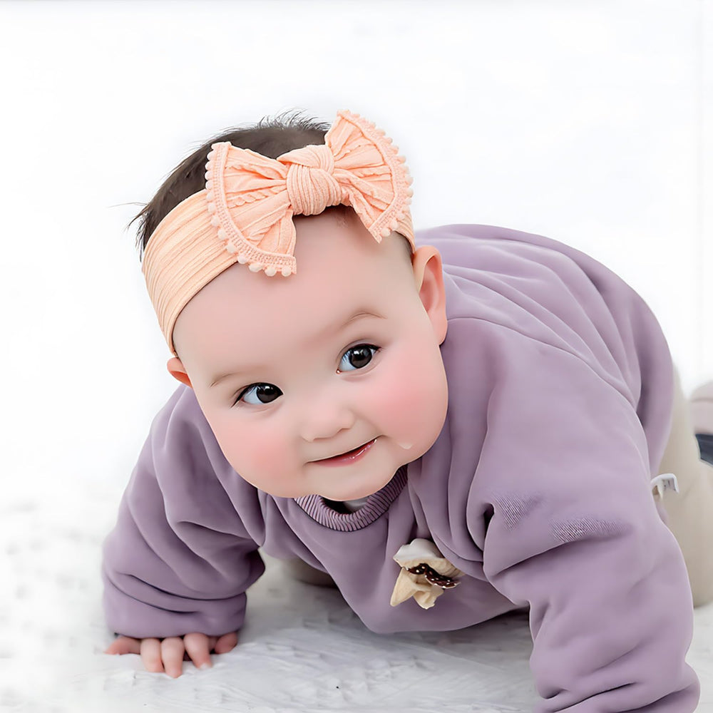 VISBL pompom trim bows close-up showing playful texture and secure wear