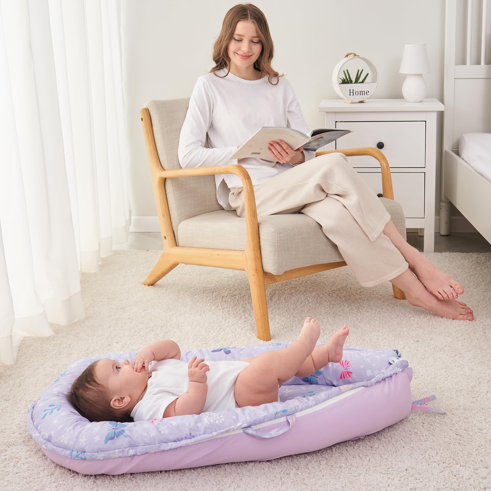 Viviland Baby Lounger Butterfly in-use on sofa for relaxed baby naps.