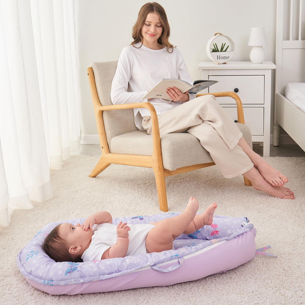 Viviland Baby Lounger Butterfly in-use on sofa for relaxed baby naps.