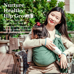 Vlokup green ring sling keeps baby in M-position for hip comfort.