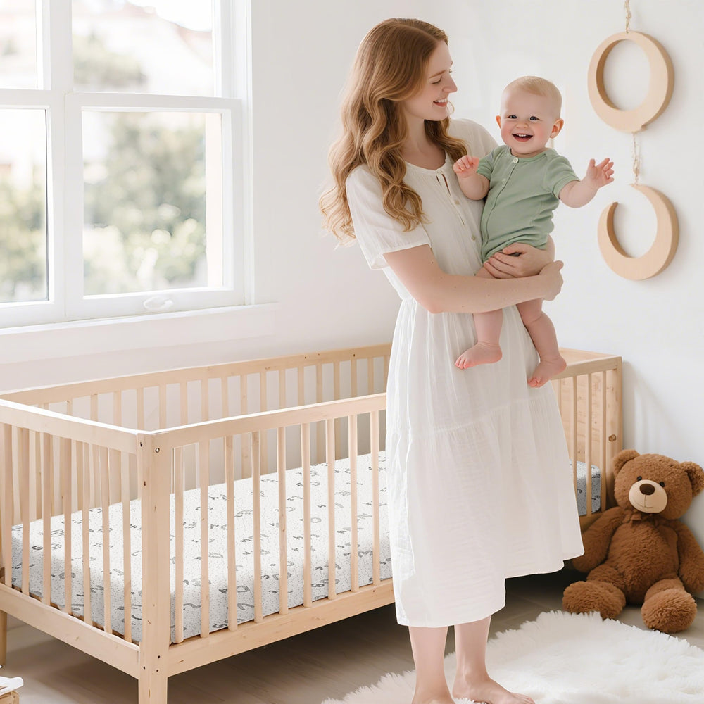 voomf pack and play mattress in a cozy nursery setup for nap-time and play