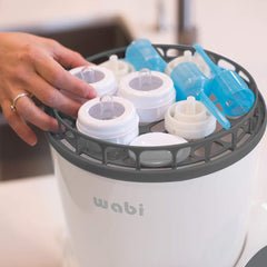 Wabi Baby Electric Steam Sterilizer interior basket view showing space for multiple bottles and accessories.