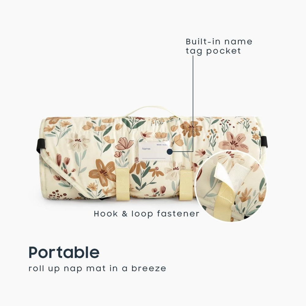 Wake In Cloud cot nap mat rolled with handle demonstrates portable design for daycare and travel.