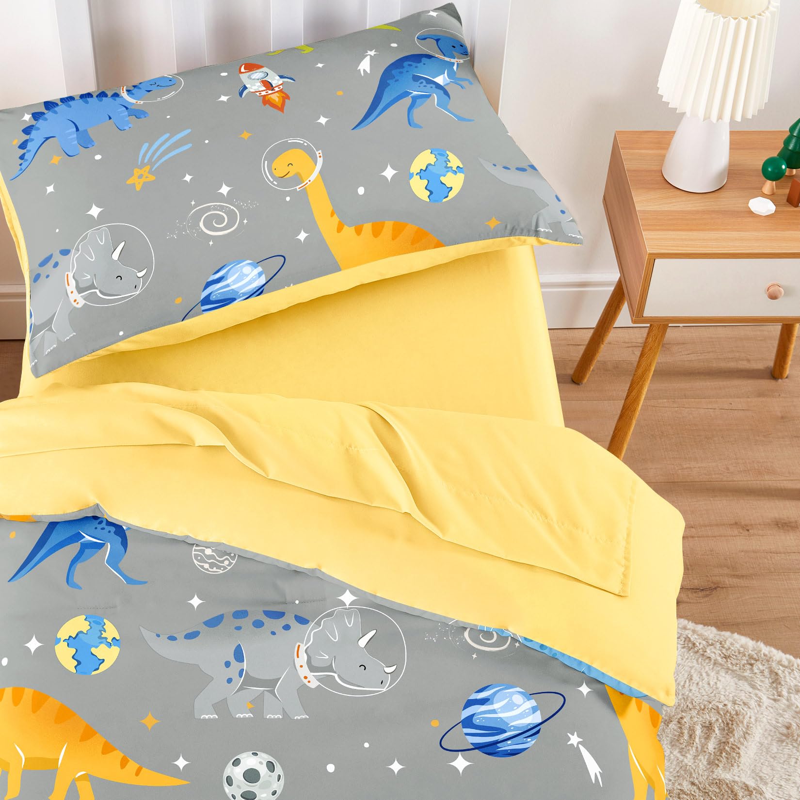 Wake In Cloud dinosaur-astronaut fitted sheet with 8in pocket fits standard toddler mattress securely