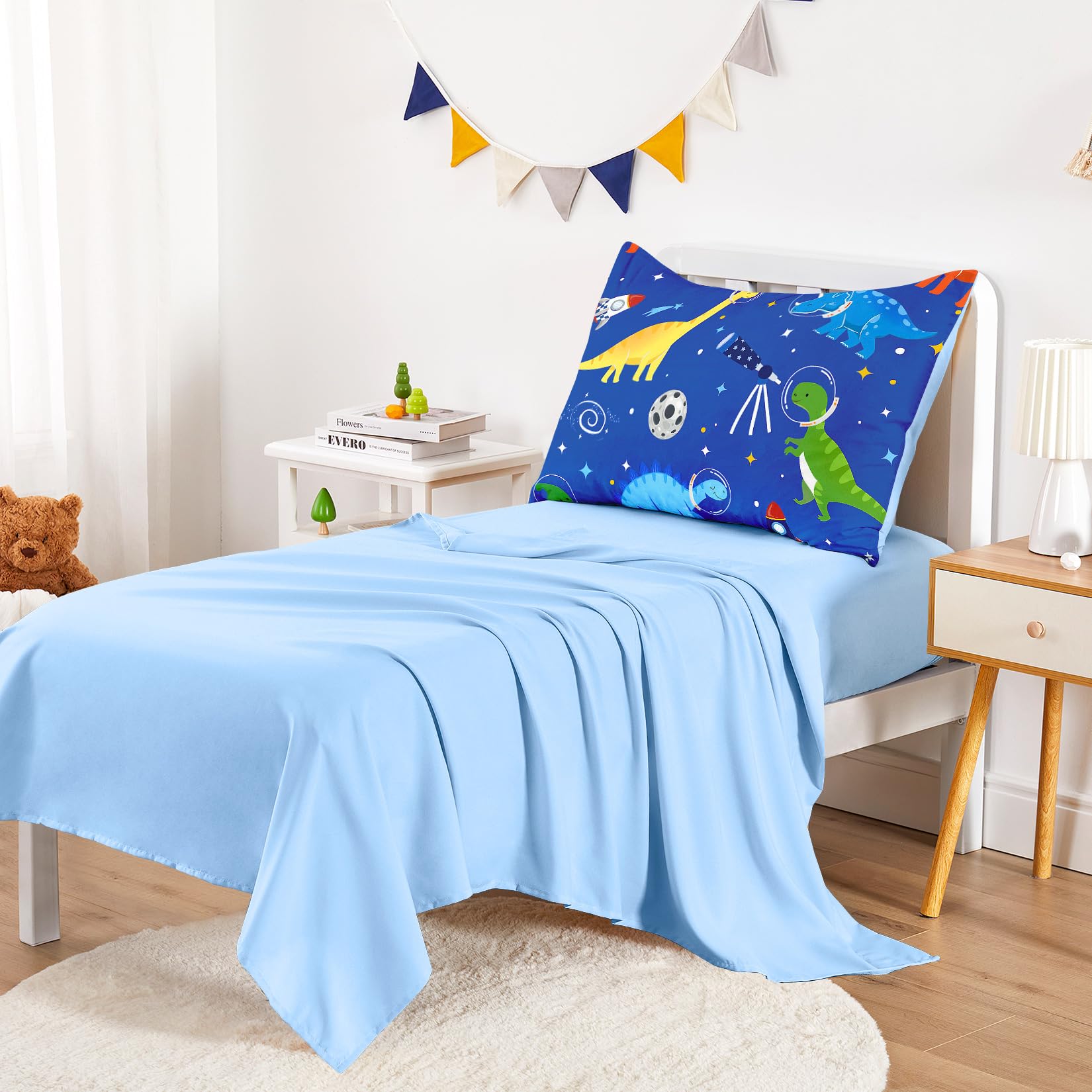 Wake In Cloud dinosaur-astronaut pillowcase closeup emphasizing soft finish for gentle bedtime prep