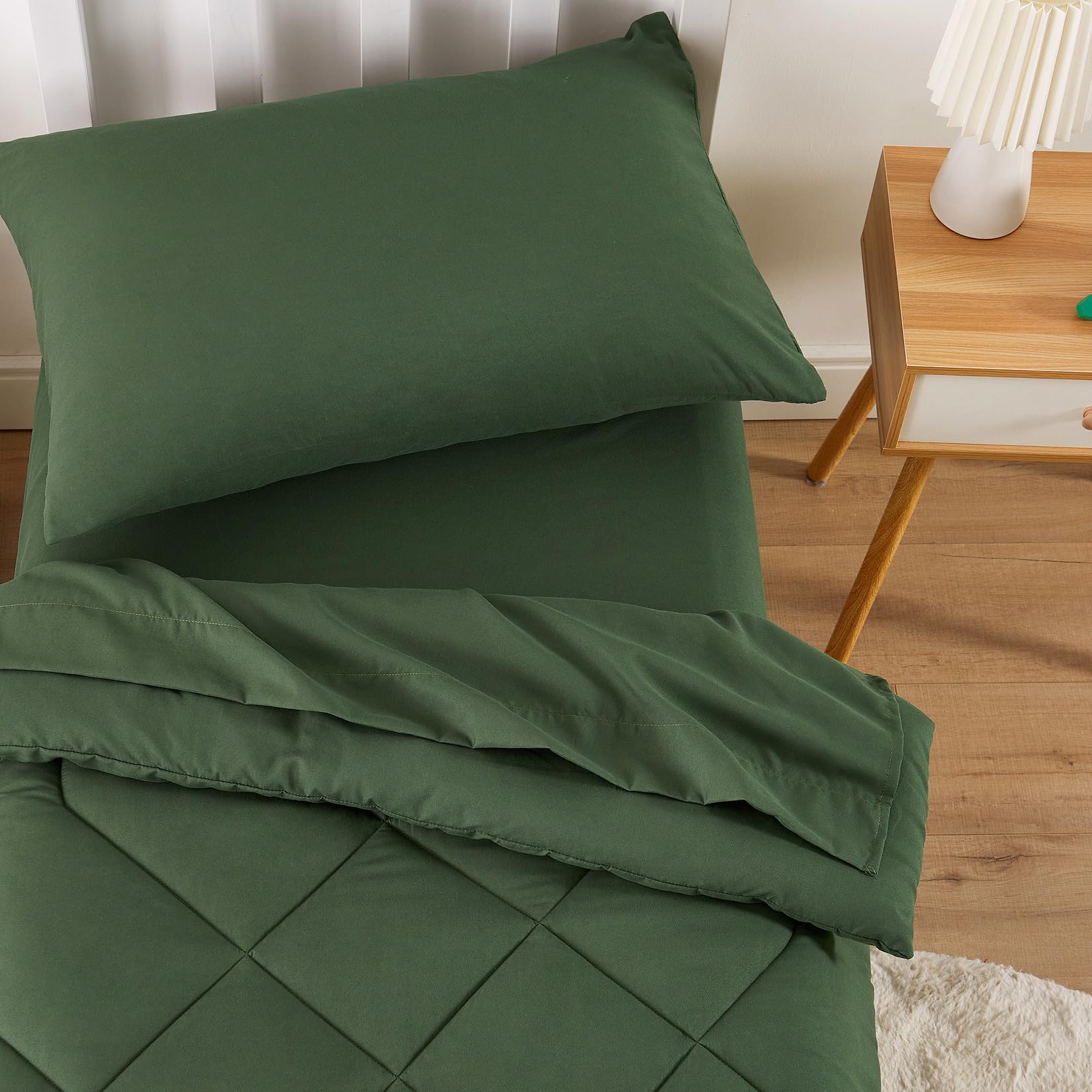 Wake In Cloud olive-green fitted sheet shows secure 8-inch pocket fit