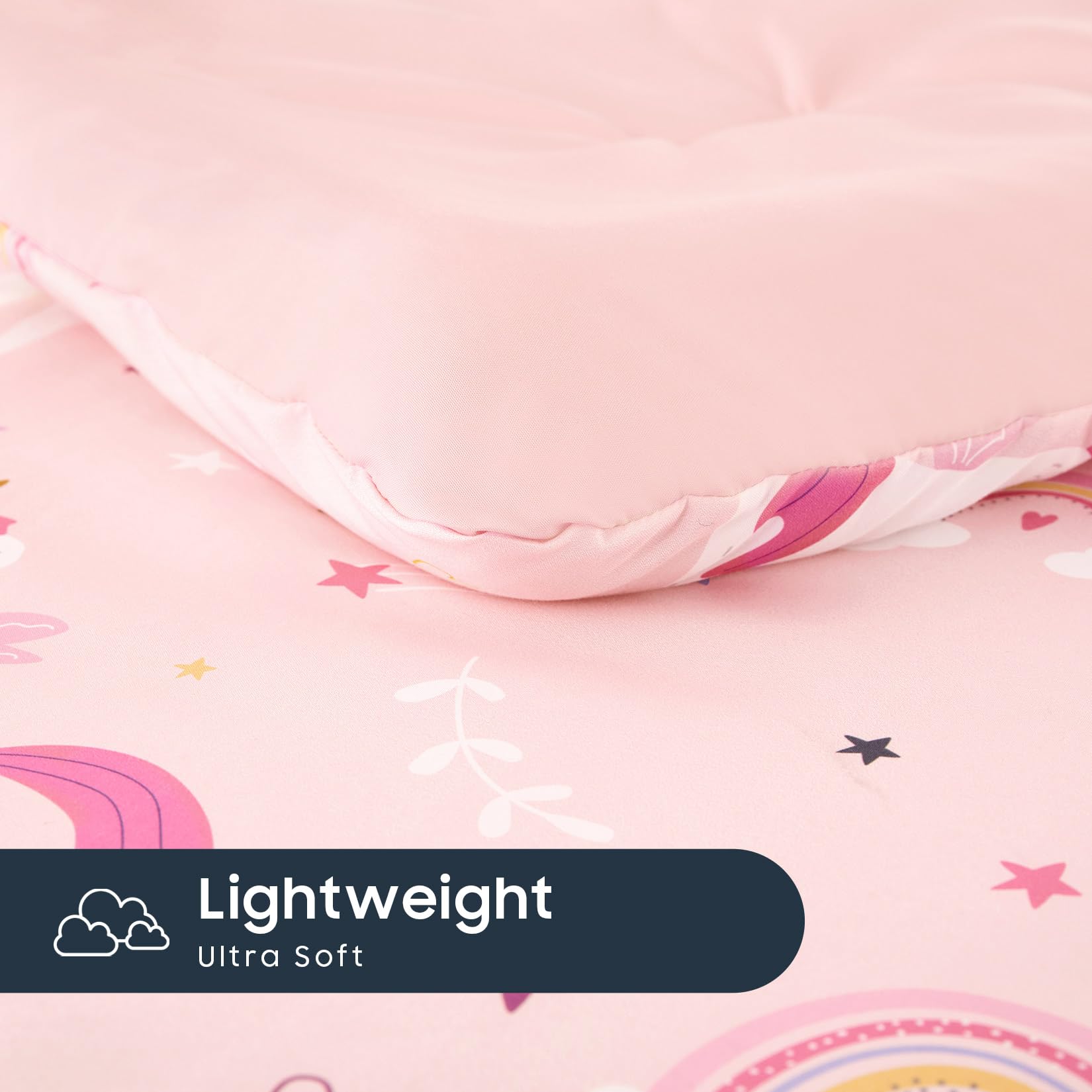 Wake In Cloud toddler bedding set pink shown on a cozy kids' bed.