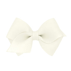 Wee Ones antique white bow closeup on WeeStay clip for secure all-day wear.