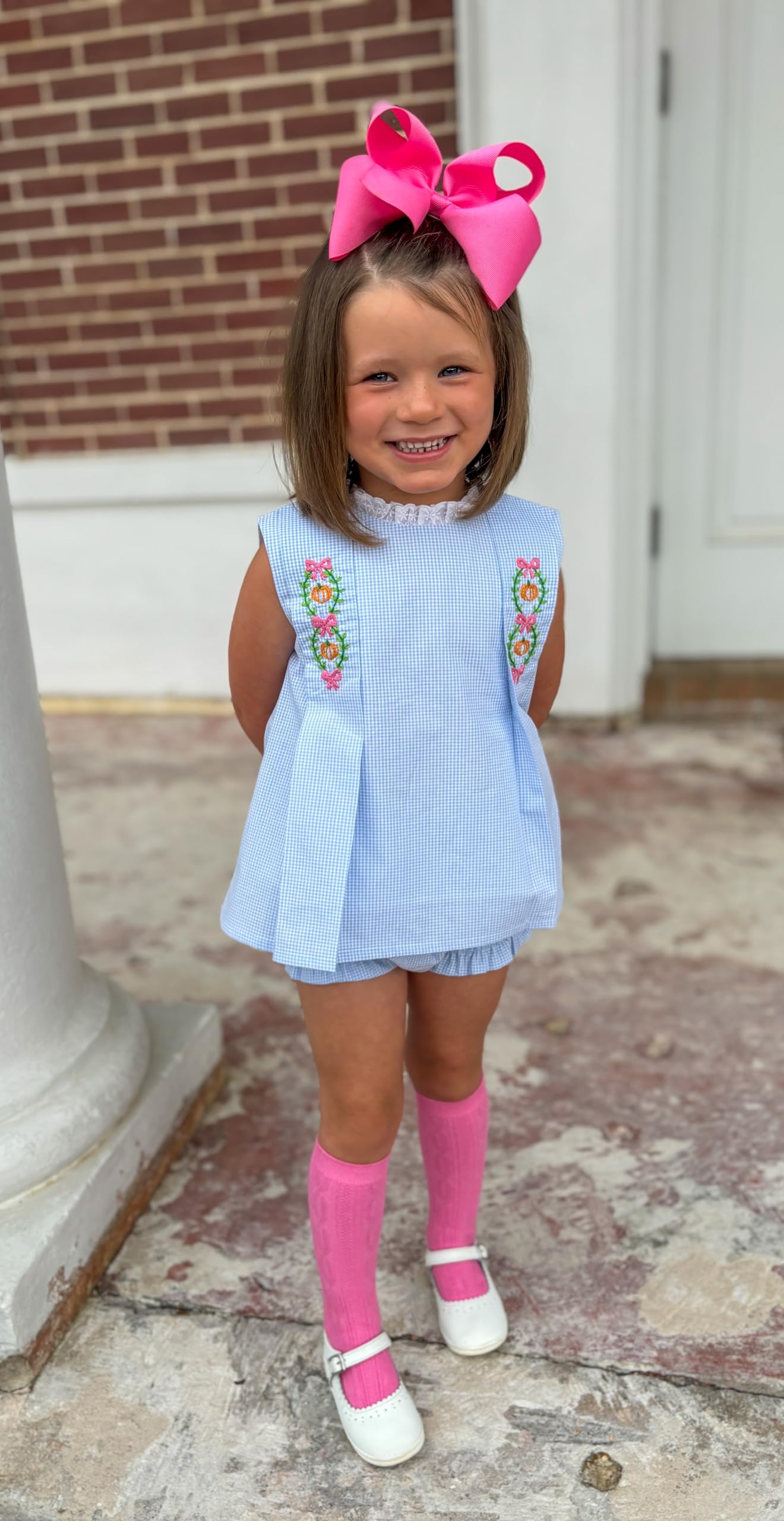 Wee Ones hot pink bow styled with pigtails for timeless everyday fashion.