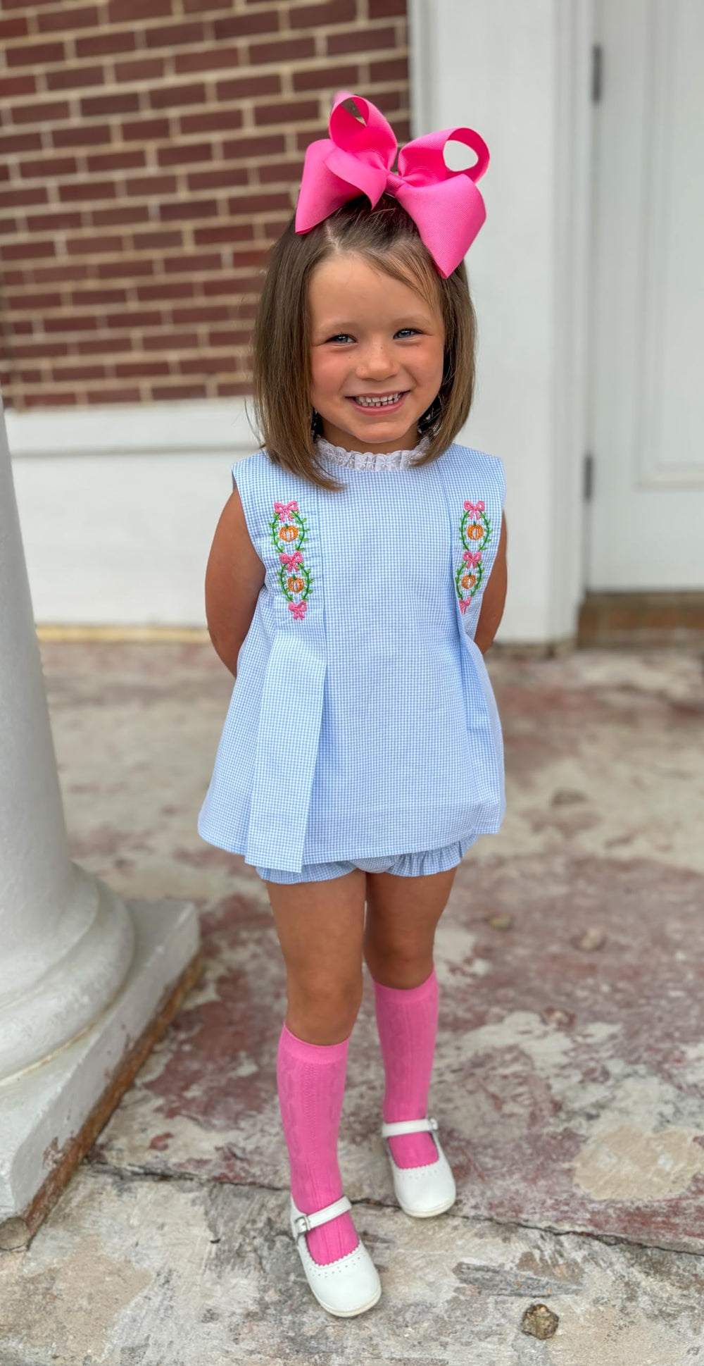 Wee Ones hot pink bow styled with pigtails for timeless everyday fashion.