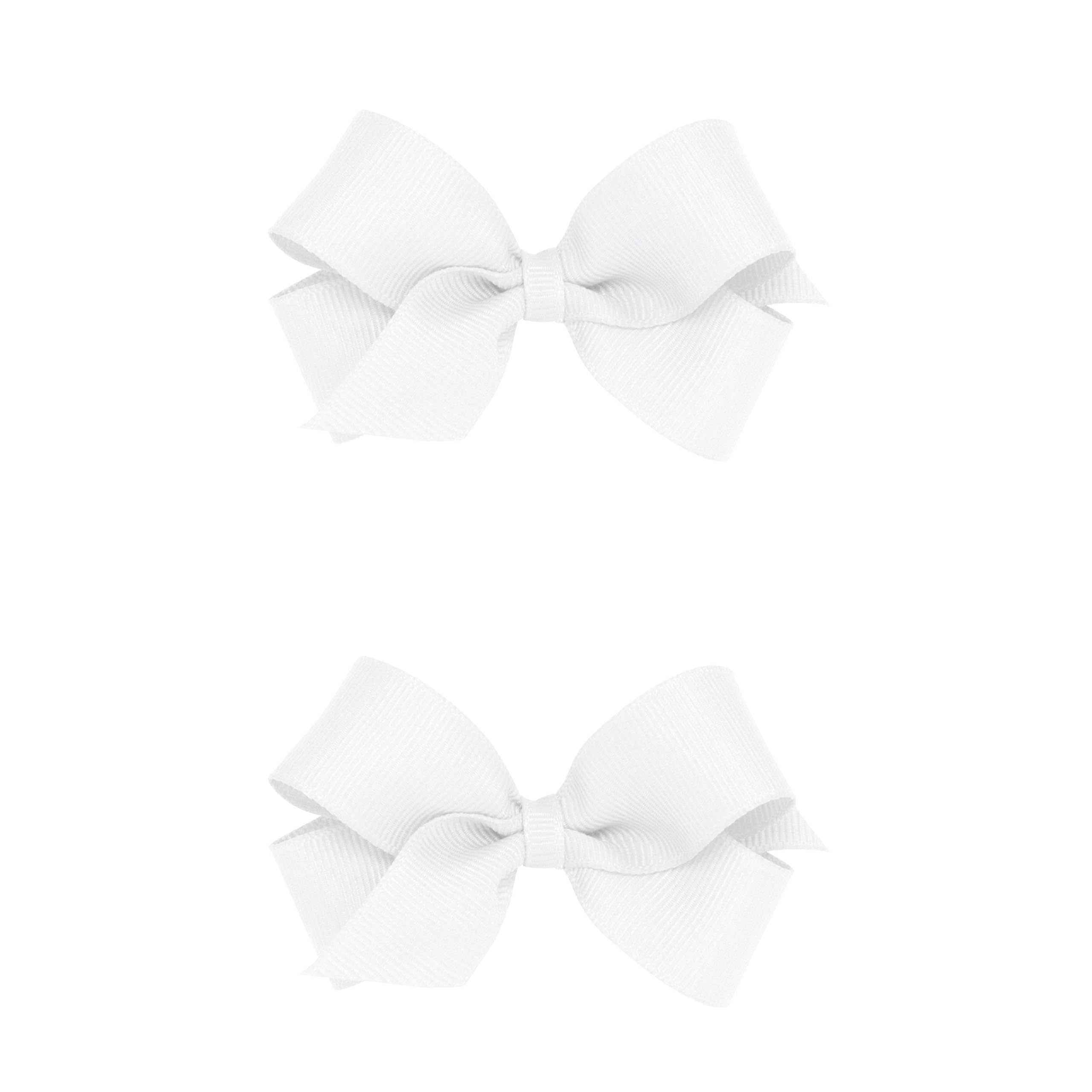 Wee Ones mini white bows on a no-slip clip showing secure hold for active kids