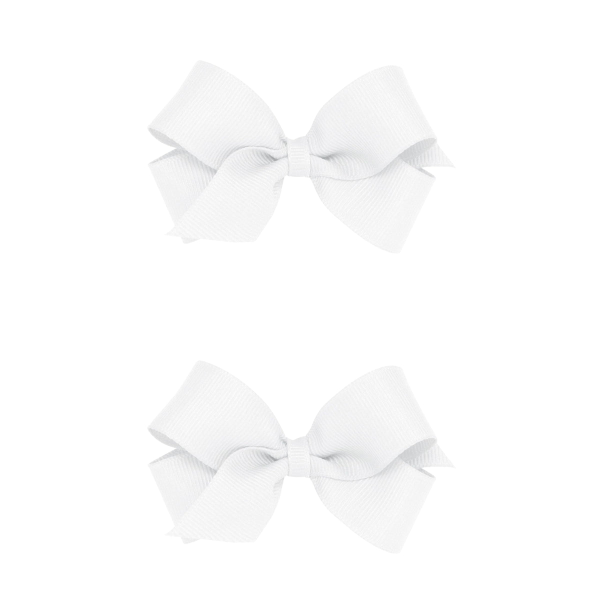 Wee Ones mini white bows on a no-slip clip showing secure hold for active kids