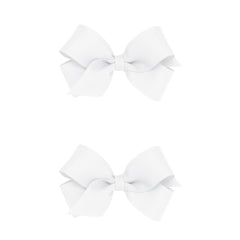 Wee Ones mini white bows on a no-slip clip showing secure hold for active kids