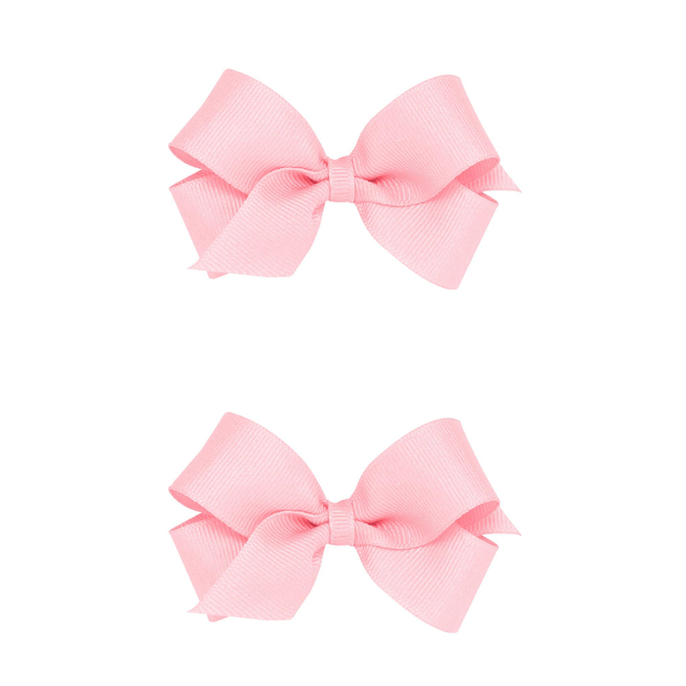 Wee Ones two-pack mini light pink grosgrain bows with a no-slip clip for secure wear.