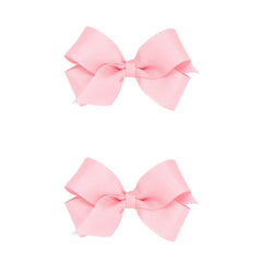 Wee Ones two-pack mini light pink grosgrain bows with a no-slip clip for secure wear.
