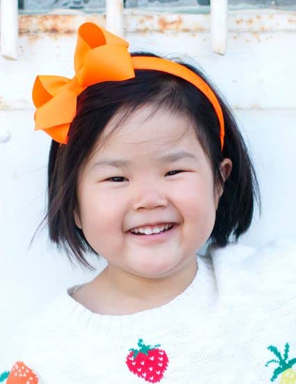 Wee Ones orange bow on wrapped headband for easy, stylish outfits.
