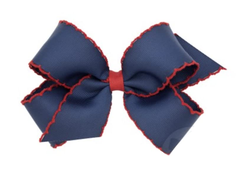 Wee Ones hair bow on navy clip showing moonstitch edge for secure all-day wear