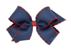 Wee Ones hair bow on navy clip showing moonstitch edge for secure all-day wear