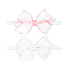 Wee Ones two mini Moonstitch bows on a skinny nylon band in light pink for versatile daily wear.