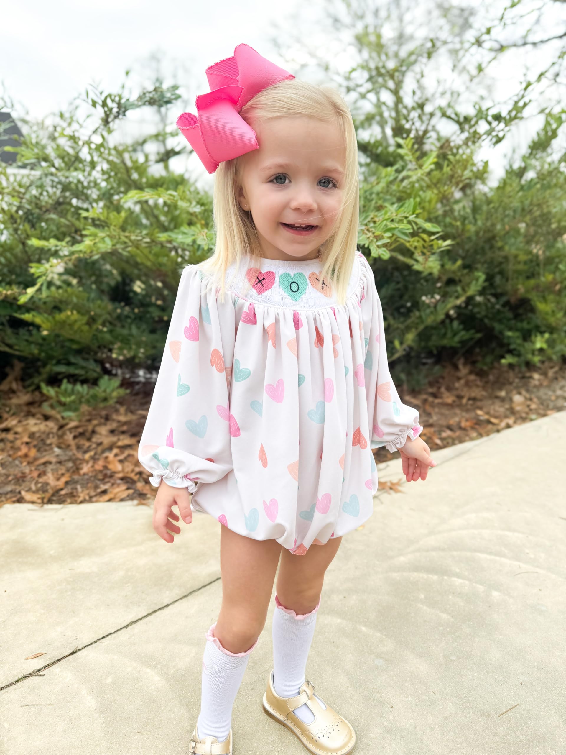 Wee Ones girl wearing hot pink bow with secure clip for everyday outfits.