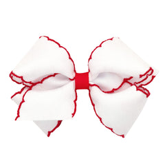 Wee Ones Moonstitch edge bow closeup on WeeStay clip showing secure grip