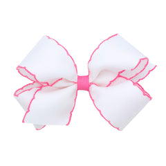 Wee Ones Moonstitch edge bow closeup shows durable grosgrain with white-pink trim