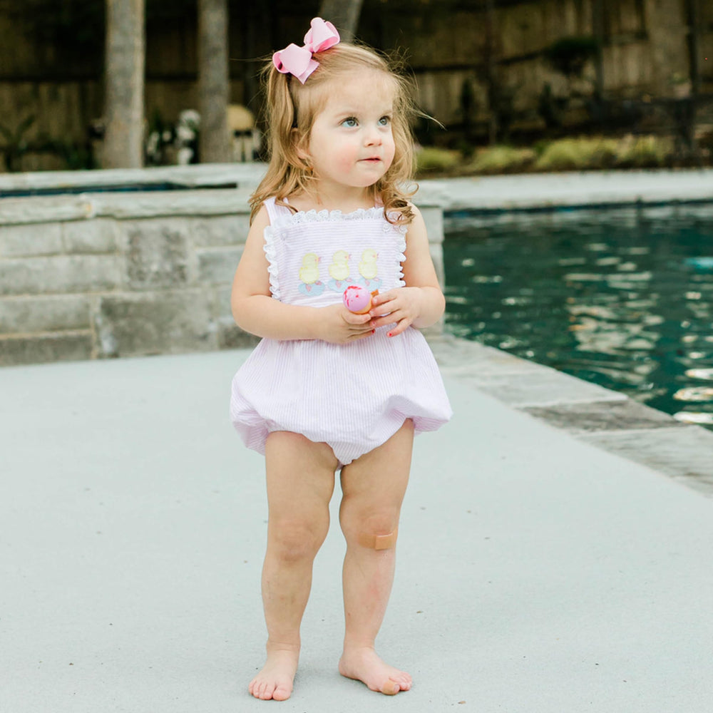 Wee Ones Pearl Pink bow on a head elevates everyday outfits with style.