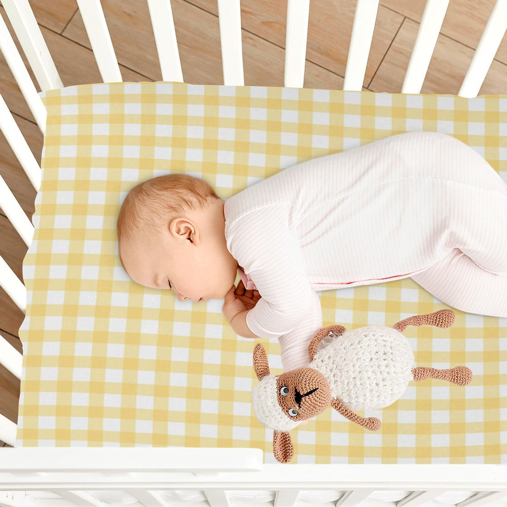 WELLDAY baby sleeping scene highlights cozy sleep setup with gingham sheets.