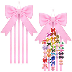 Weysat bow organizer on wall with pink bow and five ribbons for hair clips.