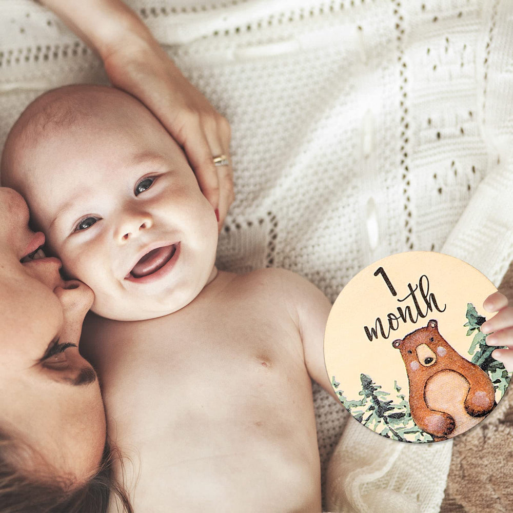 Whaline baby growth record discs in a wood finish for memory moments.