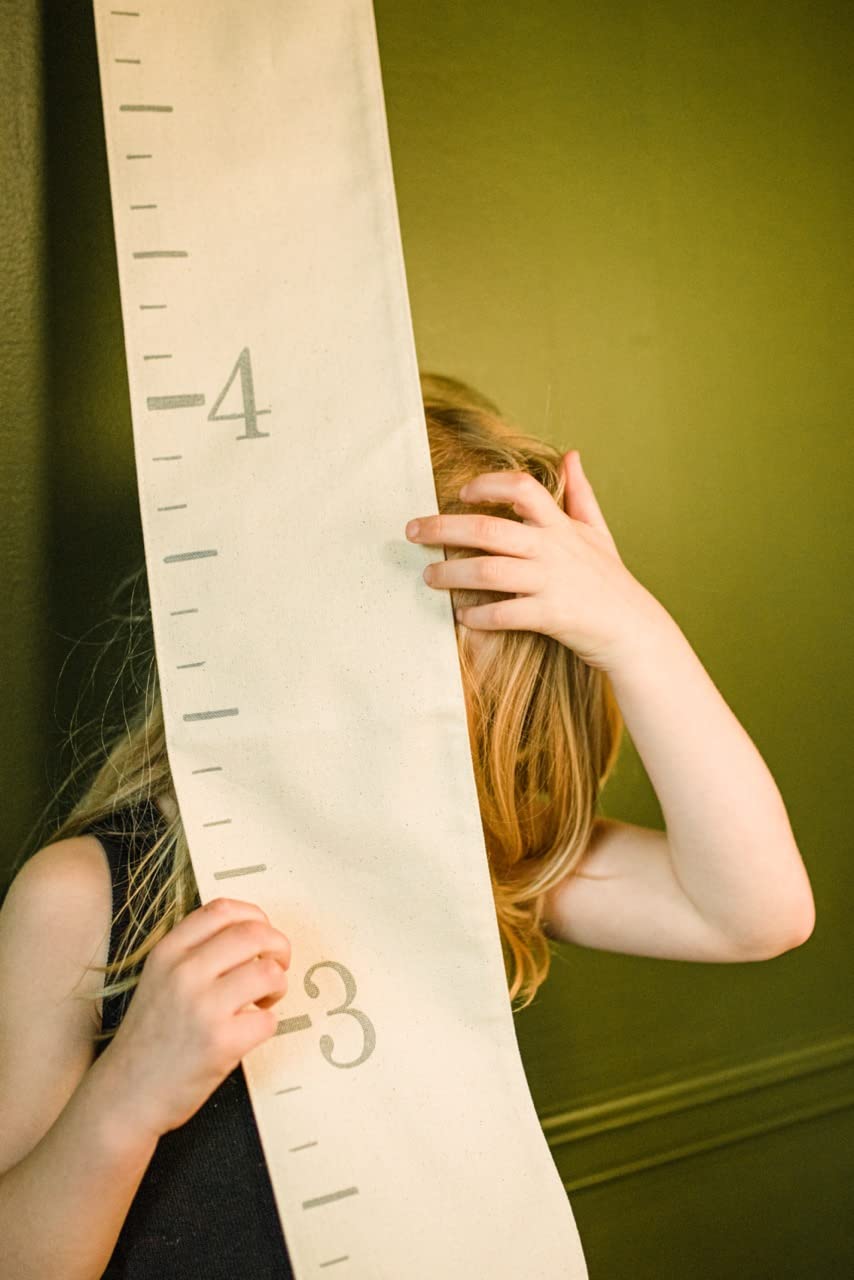White Loft portable growth chart easily relocates for nursery, hallway, or shared play spaces