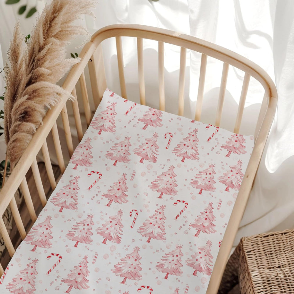Wicbfdfv pink Christmas pine crib sheet folded for easy storage and quick setup