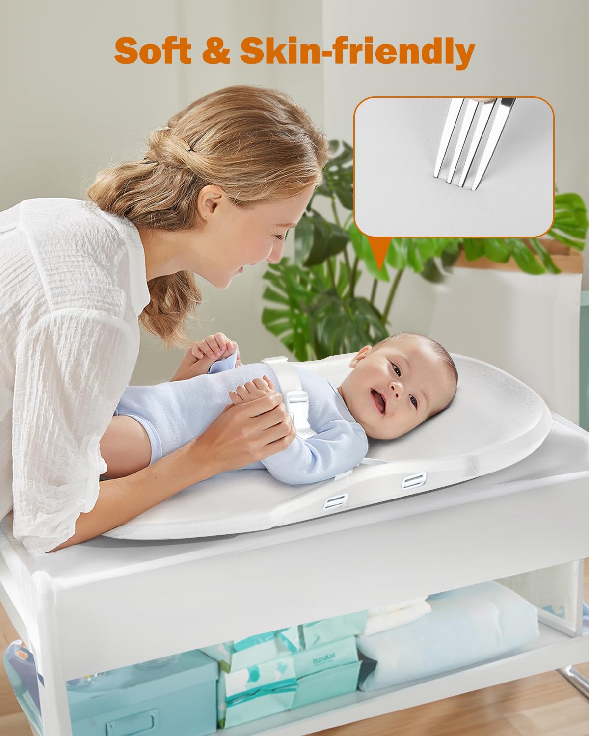 Widitn changing pad strap demonstrates secure strap for safer diaper changes.