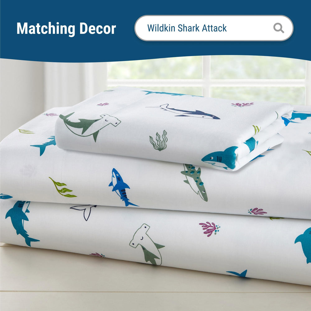 Wildkin 100% cotton crib sheet shown on a crib mattress