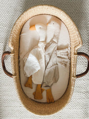 Wimist Goose Lovey rests in crib, soothing companion for naps.