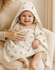 Wimist hooded baby towel Pink pattern highlights soft muslin cotton against baby skin.