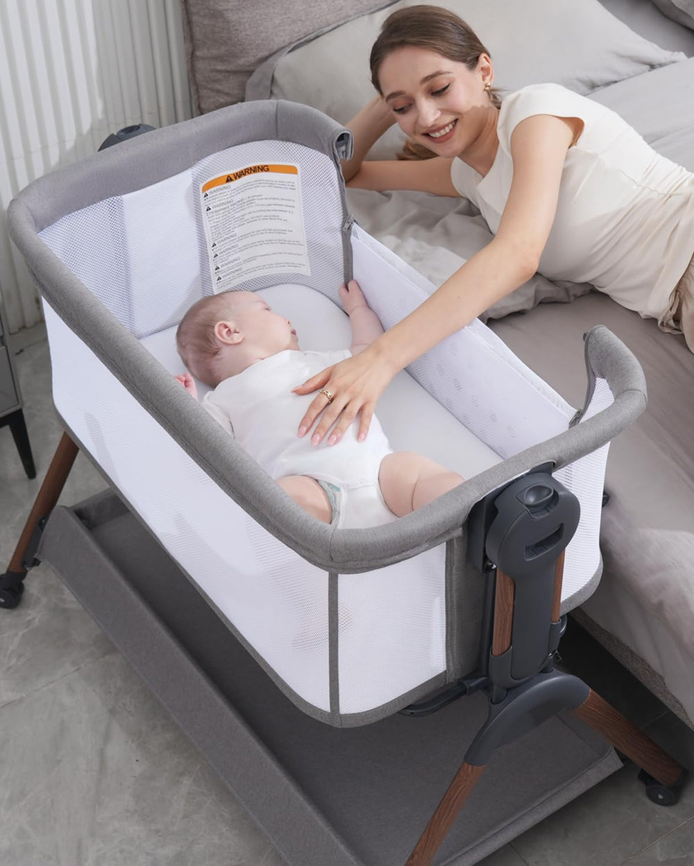 Winchild baby bassinet side-sleeper demonstrates bedside integration for easy midnight care