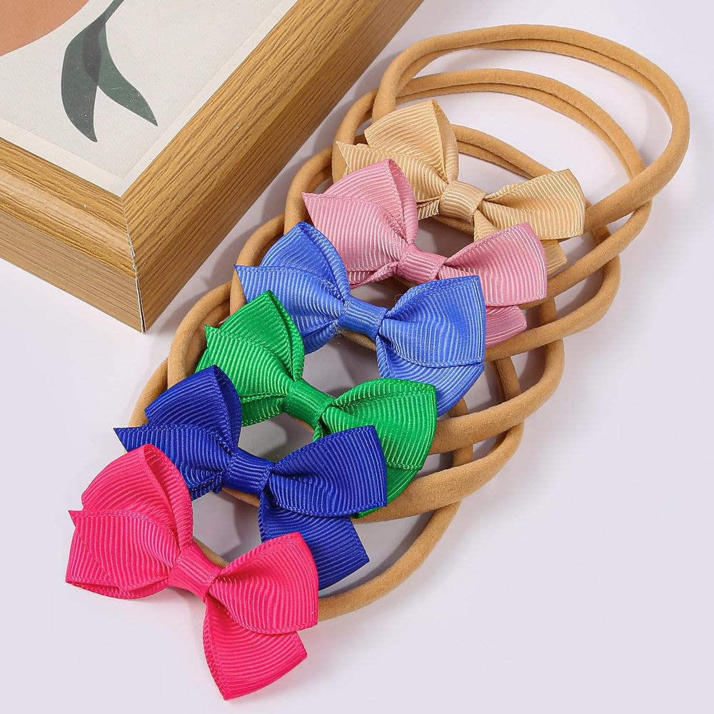 Newborn to toddler fit shown on a baby wearing WJYX BOWS.