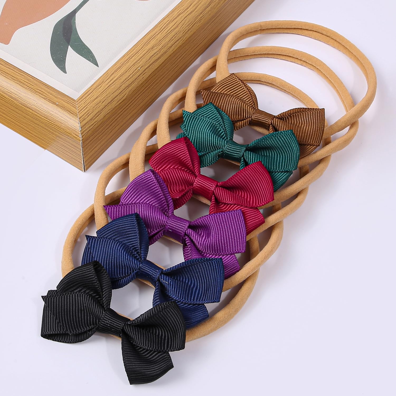 Gift-ready packaging for new parents with WJYX BOWS headbands.