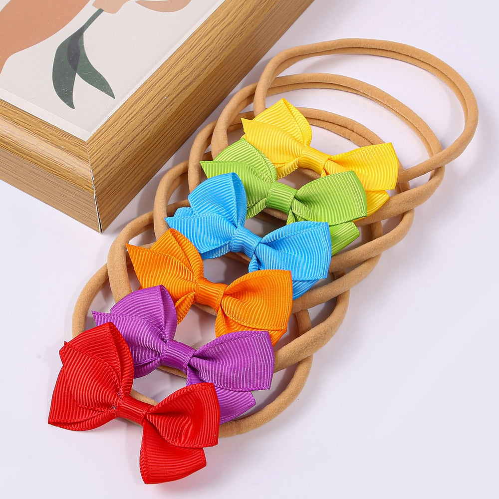 Photo-shoot-ready WJYX BOWS headbands enhance family portraits.