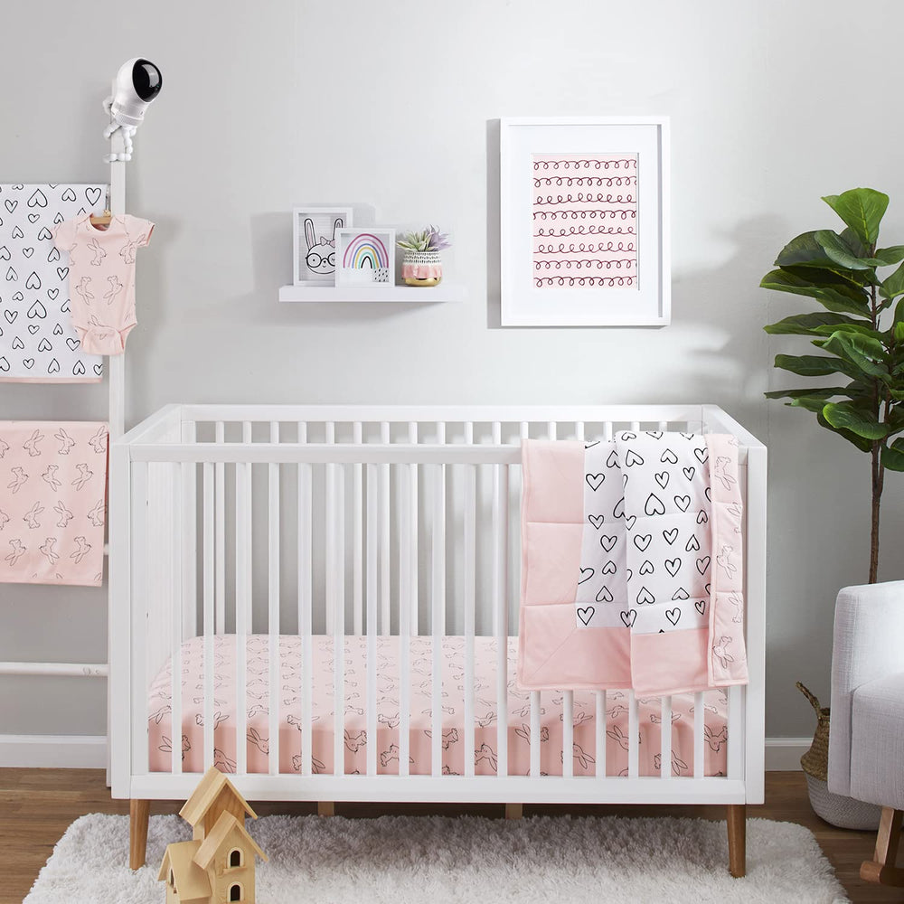 Wochel white finish blends with nursery decor while keeping monitor accessible.