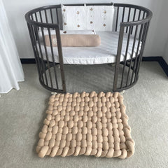 Wonder Space Knotted Braided Plush Mat baby tummy time image shows gentle cushioning