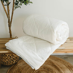 Woolino crib-size duvet insert displayed on a crib