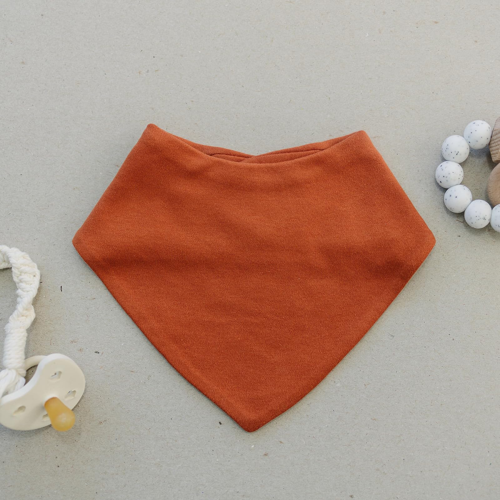 Woolino Merino baby bibs fabric closeup highlighting hypoallergenic softness against skin.