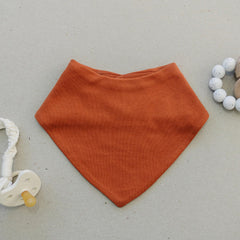 Woolino Merino baby bibs fabric closeup highlighting hypoallergenic softness against skin.