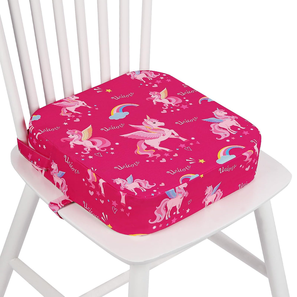 Wooshwa unicorn toddler booster seat on a dining chair for stable, confident mealtimes.