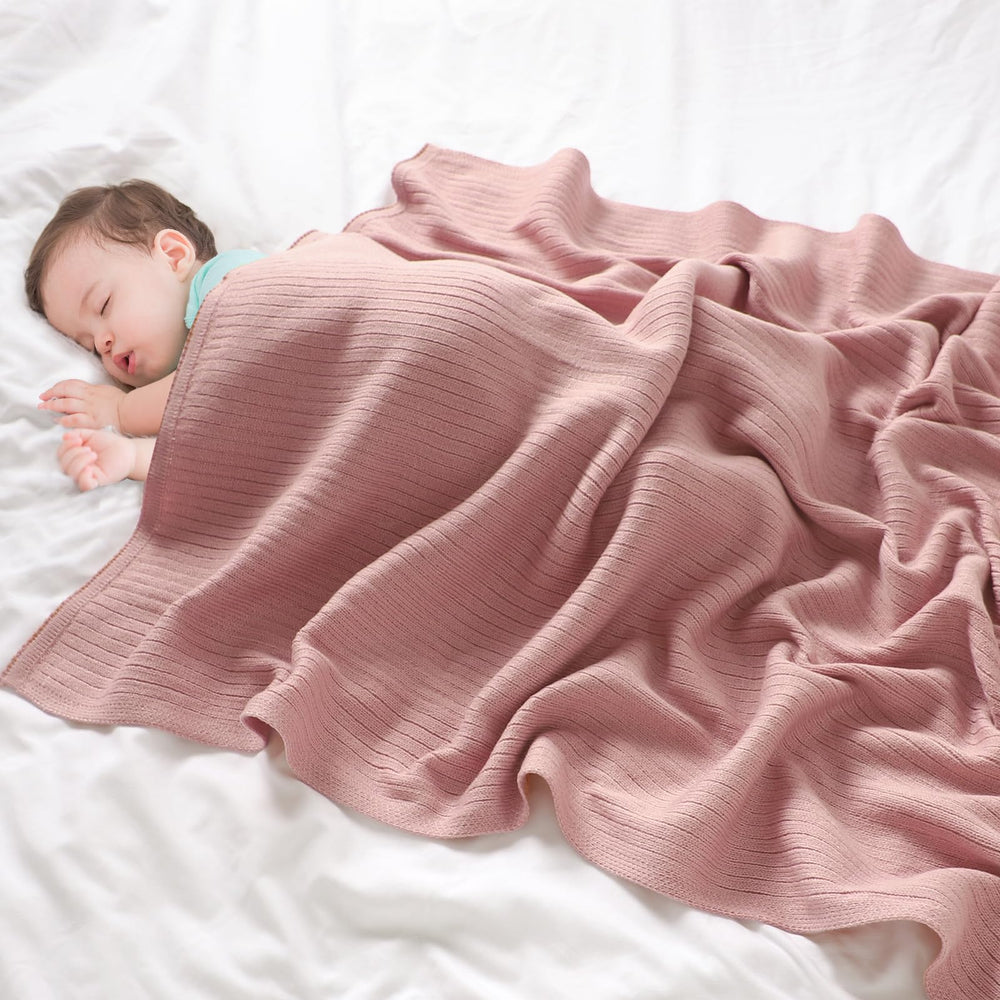 Wugugu baby blanket in crib demonstrates soft fabric for nap time.