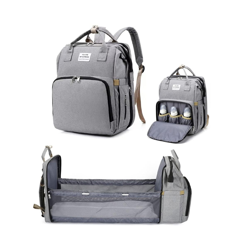 X W EI UNION diaper backpack with changing station used outdoors for easy diaper changes.
