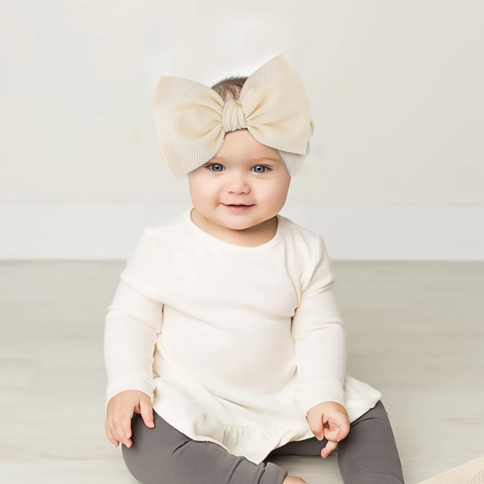 YanJie 3pcs 7in big bows headbands in light pink add soft, adorable detail.